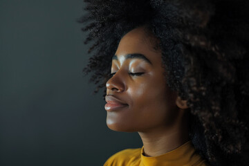 A close up of a black woman's face with her eyes closed looking to a side