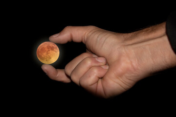Man keeping the moon in his hand. Flower moon. May full moon. Τwo photos joined.