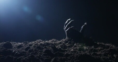 Zombie hand rising out from the ground