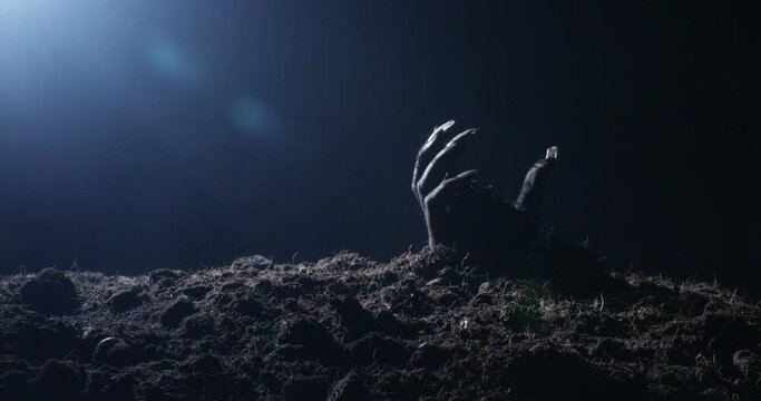 Zombie hand rising out from the ground