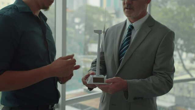 Cropped shot of ecologists holding mockup when discussing wind power implementation in business of client