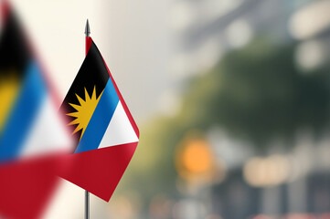 Small flags of Antigua and Barbuda on a blurred background