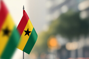 Small flags of Ghana on a blurred background