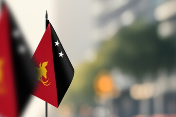 Small flags of Papua New Guinea on a blurred background