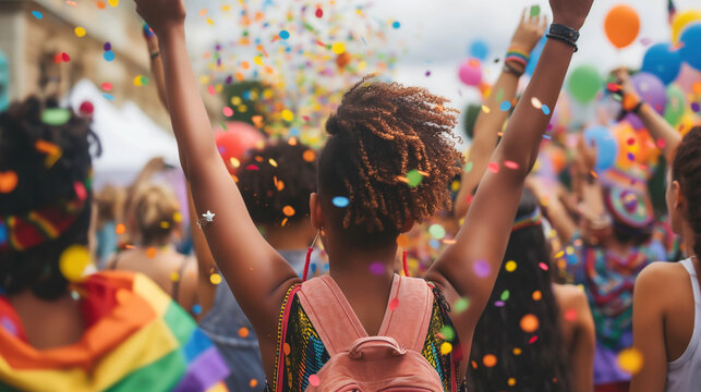 A happy group of diverse young people celebrating on pride festival parade together, freedom, equality and acceptance, LGBTQ community concept.