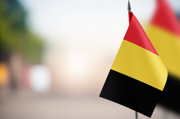 Small flags of Belgium on a blurred background