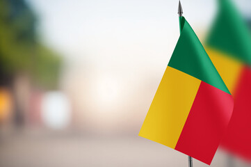 Small flags of Benin on a blurred background
