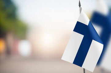Small flags of Finland on a blurred background