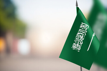 Small flags of Saudi Arabia on a blurred background