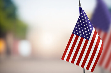 Small flags of USA on a blurred background
