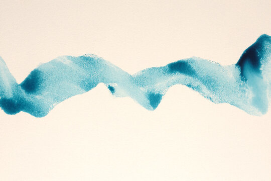 Ink watercolor hand drawn pour flow painting smear brushstroke line blot. Wave blue beige wall grain texture background.