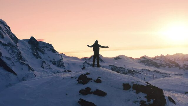 Fear Challenge Success Achievement Epic Aerial Of Successful Climber Raising Arms Success Standing Up On Mountain Top At Sunset Winter Mountains Alps Healthy Lifestyle Business Success Concept