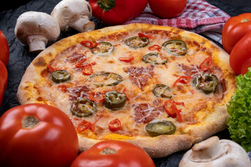 spicy chorrizo pizza with jalapeno peppers close-up