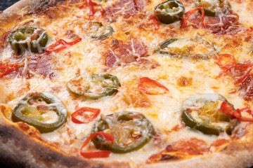 spicy chorrizo pizza with jalapeno peppers close-up