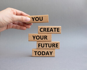 Future and development symbol. Wooden blocks with words You Create your Future today. Businessman hand. Beautiful grey background. Business and Future and development concept. Copy space.