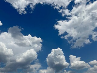 Fluffy clouds in the blue sky.