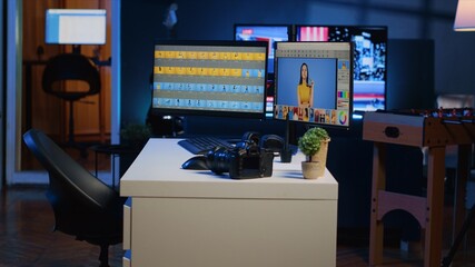 Dimly lit creative office in media agency with multi monitor computer setup used for image retouching, panning shot. Photography studio with editing software interface on PC screens and camera on desk
