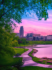 Omaha City Skyline at Sunrise over the Conagra Lake and vibrant green forest at the Heartland of...