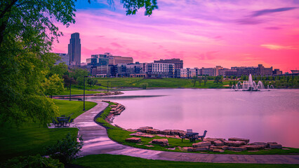 Omaha City Skyline at Sunrise over the Conagra Lake and vibrant green forest at the Heartland of...