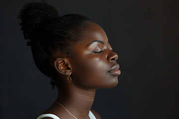 A close up of a black woman's face with her eyes closed looking to a side