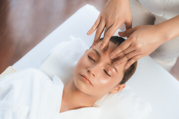 Caucasian woman enjoying relaxing anti-stress head massage and pampering facial beauty skin...