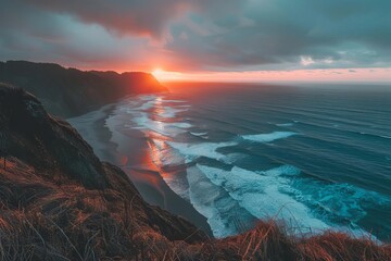 Naklejka premium Majestic scenic overlook on a cliff, with a sweeping view of the ocean, crashing waves below, and a dramatic sunset on the horizon