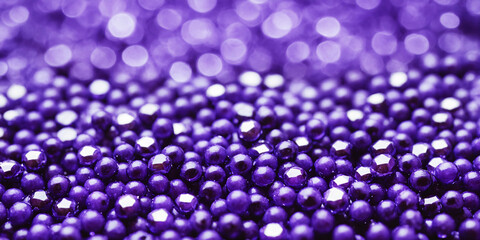 Close-up of Shiny Purple Beads with Glittering Bokeh