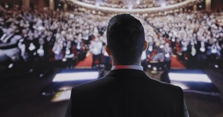 Successful Young Businessman Lecturer Speaking at Large Crowd Political Tech Corporate Summit Applause Success Charisma Financial CEO UHD 4K