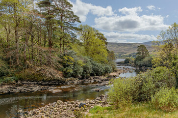 View down a stoney river as it makes its way to a sea lough