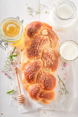 Delicious and fresh golden challah with honey and milk.