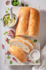 Tasty and homemade bread served with herbs and garlic oil.