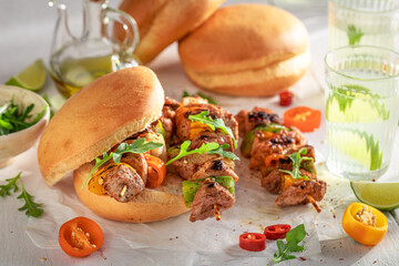Hot grilled shashlik with bun as healthy snack for bbq.