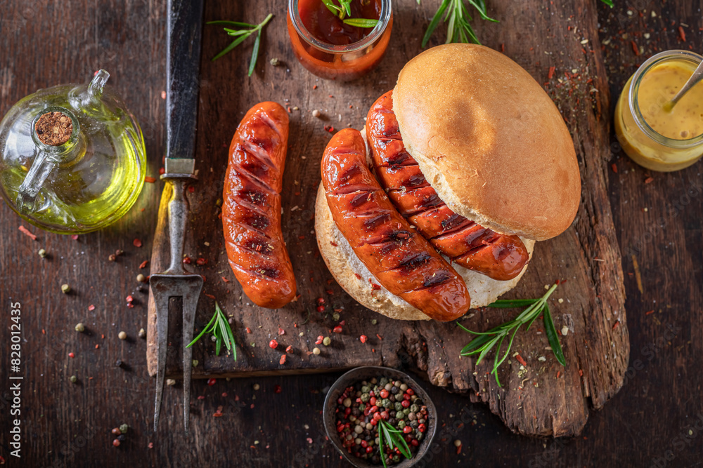 Wall mural spicy grilled sausage with bun and mustard and ketchup.