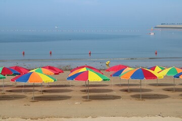 Colorful umbrellas on the beach in the morning