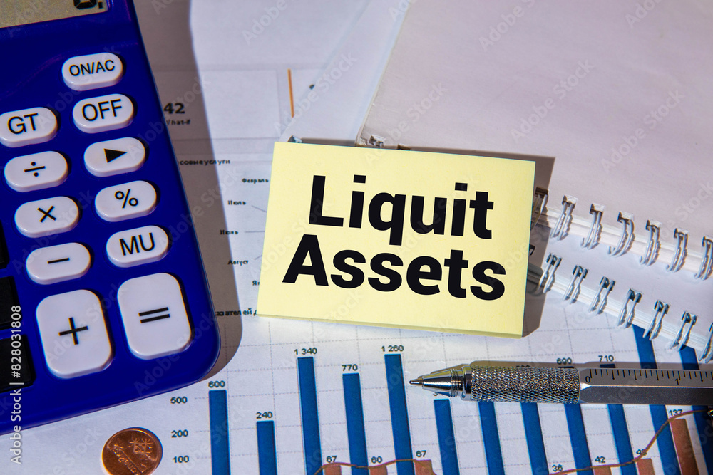 Poster liquid assets. text on notepad on white background