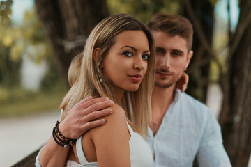 Fototapeta premium Man and woman smiling on a bench