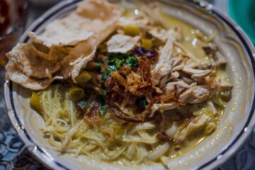 A bowl of delicious soto with complete toppings