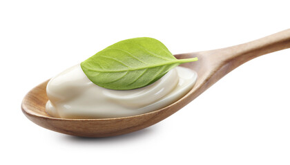 Spoon with delicious yogurt and basil isolated on white