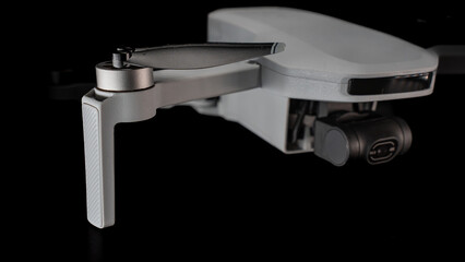 Detailed view of a drone camera against a black backdrop, showcasing intricate details.