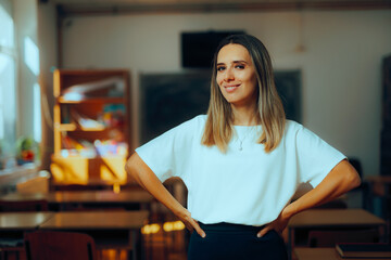 Happy Teacher Standing in a Classroom During Break Session. Professional portrait of a school worker in the workplace
