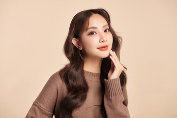 Beautiful young asian woman with clean fresh skin on beige background, Face care, Facial treatment,...