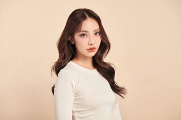 Obraz premium Beautiful young asian woman with clean fresh skin on beige background, Face care, Facial treatment, Cosmetology, beauty and spa, Asian women portrait.