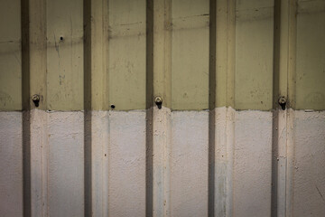 Color horizontal photo of a corrugated iron fence with vertical stripes. Textured photo of an abstract background.