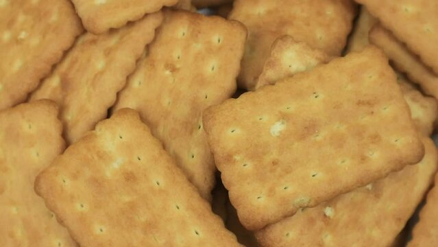 Pile of brown rectangular butter biscuits on rotary display