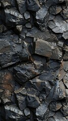 A close up of a rock wall with a black and grey color scheme