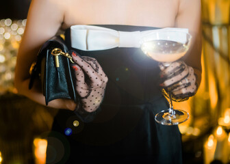 Girl a party with champagne and handbag 