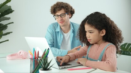 American daughter learning to coding and writing engineering prompt while positive smart father...
