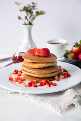Stack of pancakes hotcakes with honey and strawberries breakfast food american style