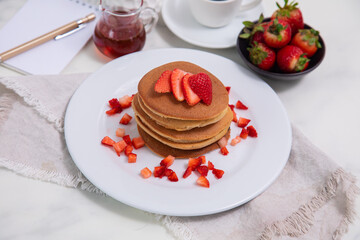 Stack of pancakes hotcakes with honey and strawberries breakfast food american style