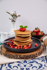 Stack of pancakes hotcakes with honey and strawberries breakfast food american style